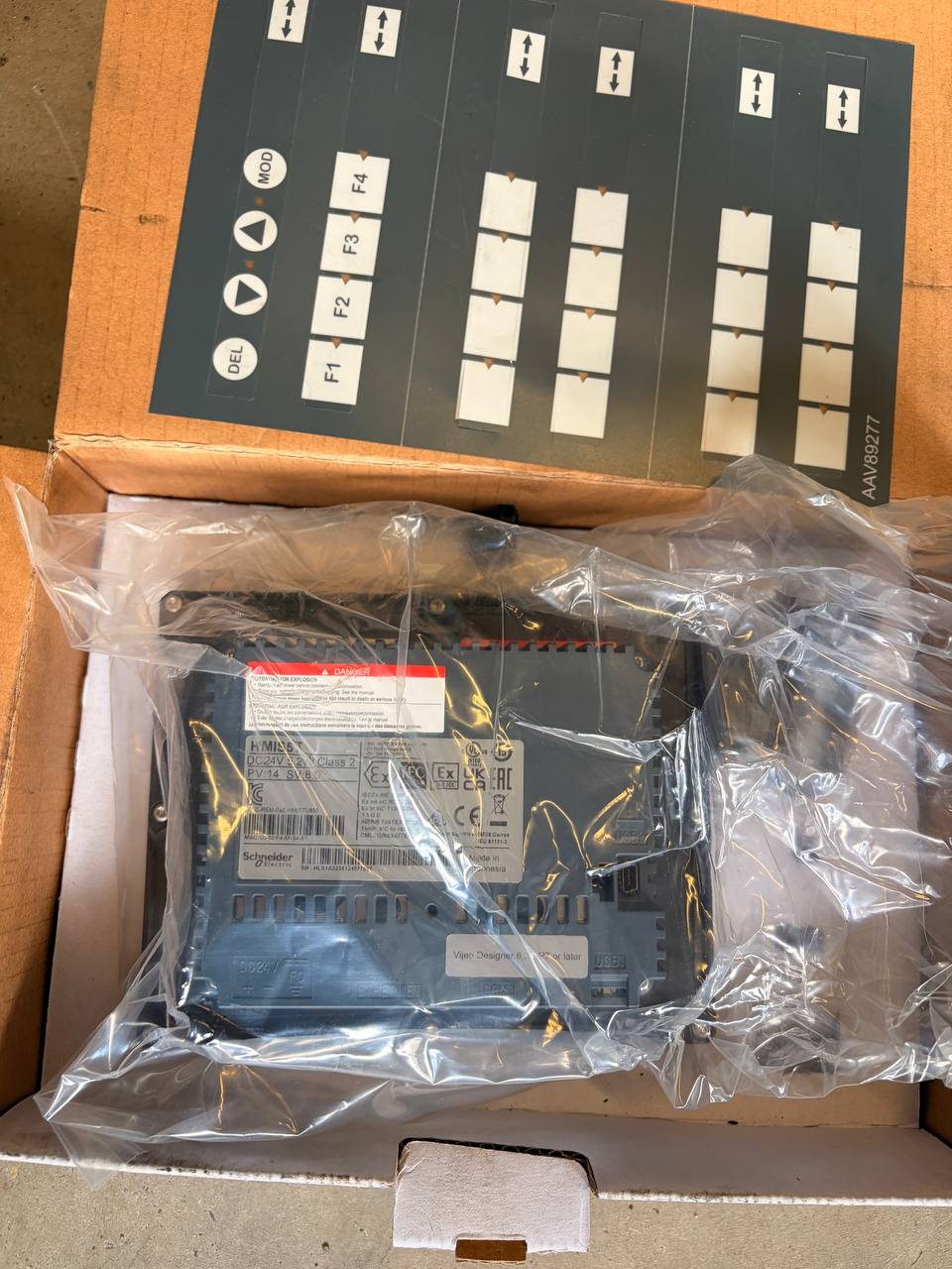Electrical control panel in clear plastic wrap on a cardboard box