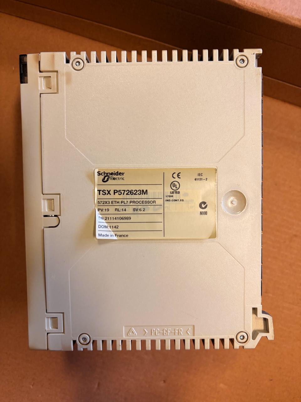 Schneider Electric TSX P57262B3M S7541 ETH-P12 processor module on a brown cardboard surface.