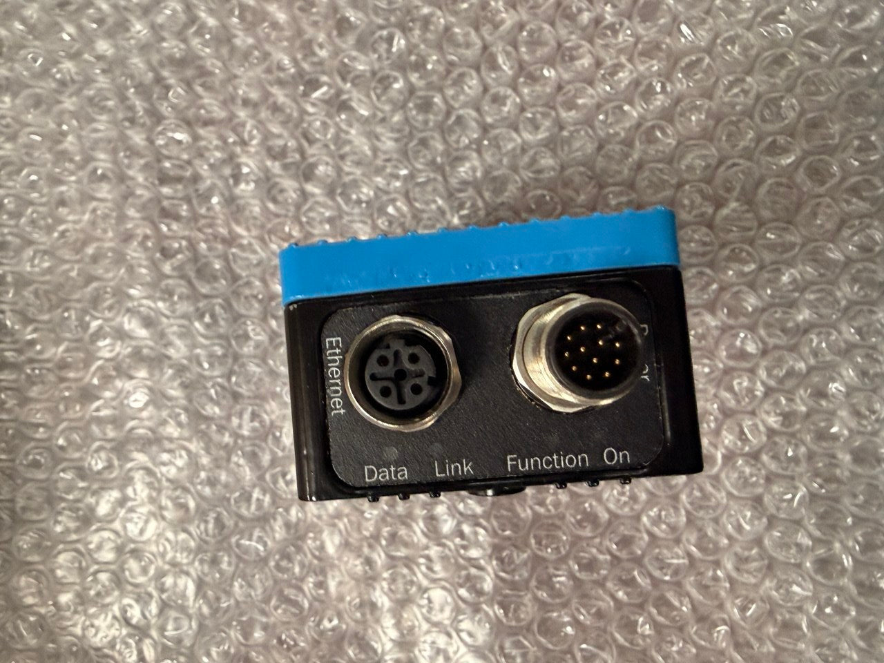 Small electronic connector with two sockets on a bubble wrap background