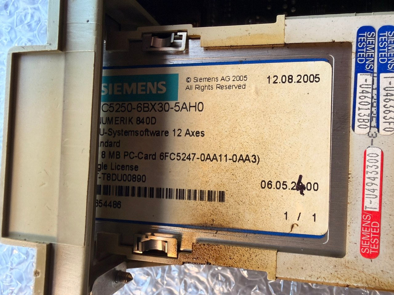 Siemens Sinumerik memory card electronic component with labels and barcodes on a metallic surface