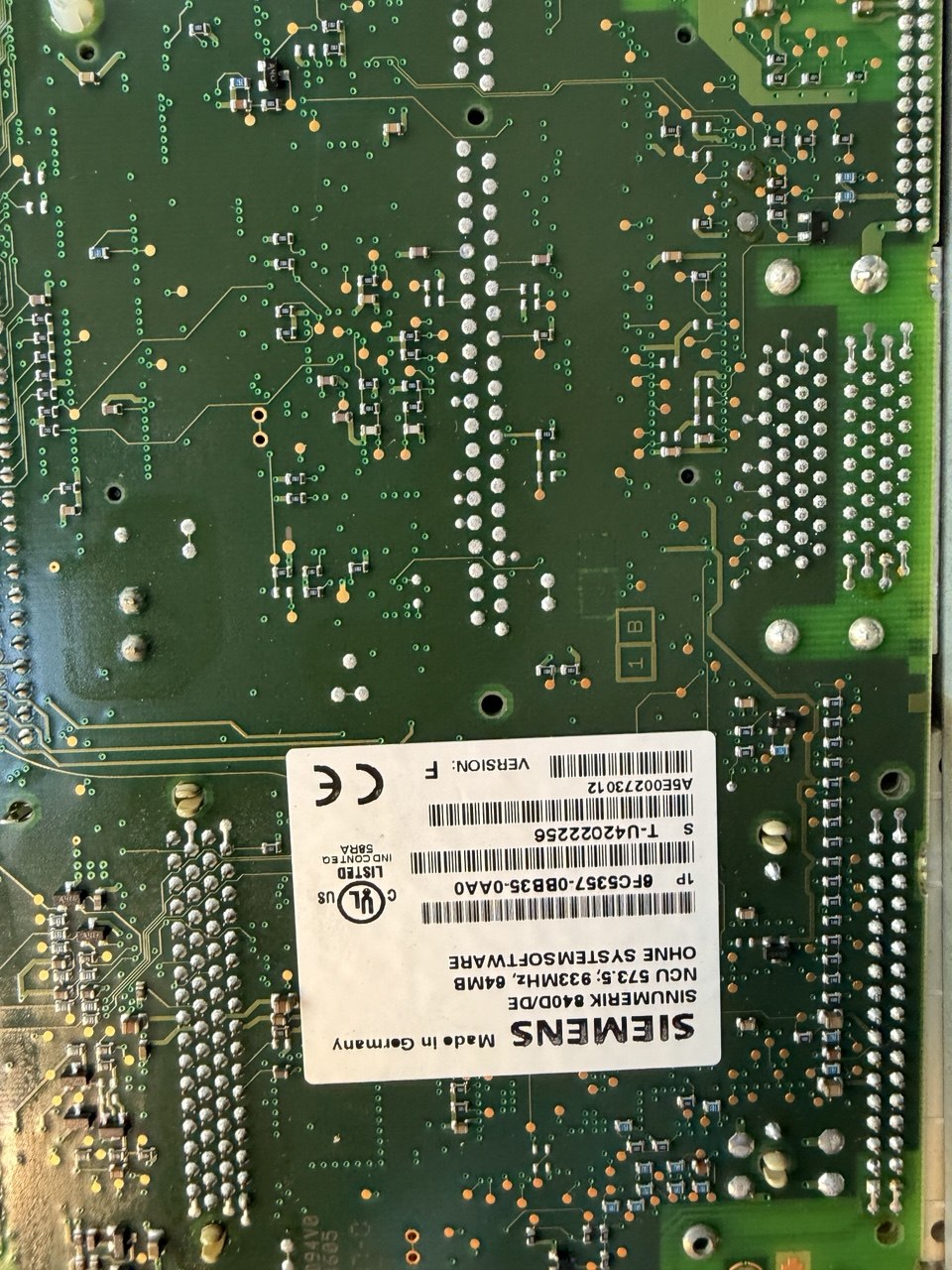 Close-up of a Siemens NCU Sinumerik electronic circuit board with various components.