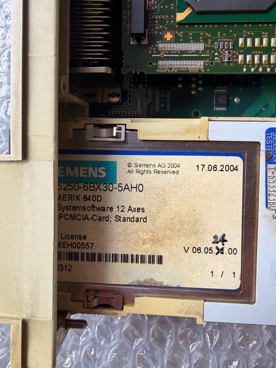 Close-up of a Siemens electronic component with a label on a metallic surface.