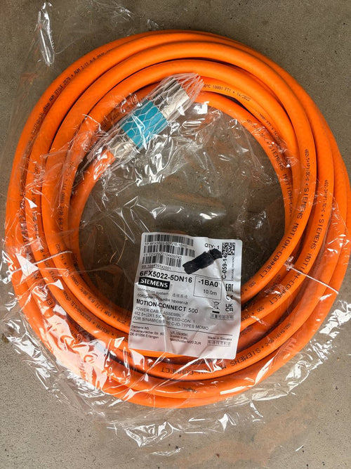 Coiled orange cable with a label on a gray background
