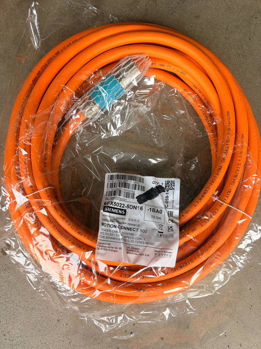 Coiled orange cable with a label on a gray background