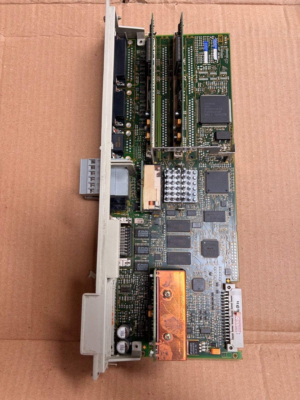 Siemens Computer motherboard on a cardboard surface