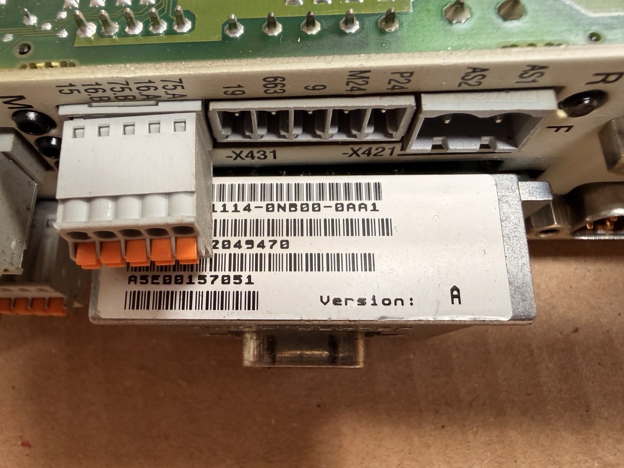 Siemens Close-up of electronic components with labels and barcodes on a brown surface
