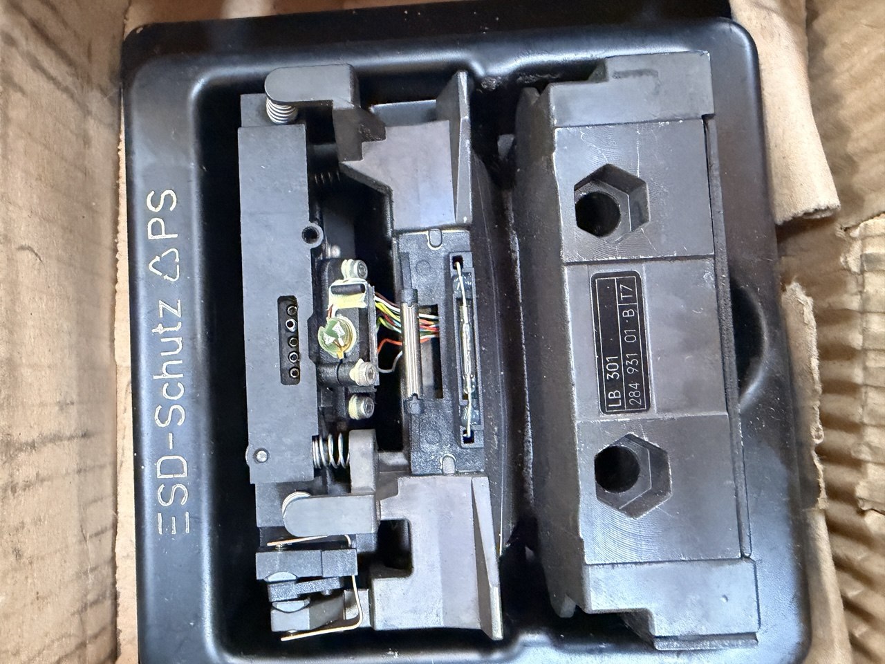 Electrical switchgear with 'ESD-Schutz' branding on a cardboard background
