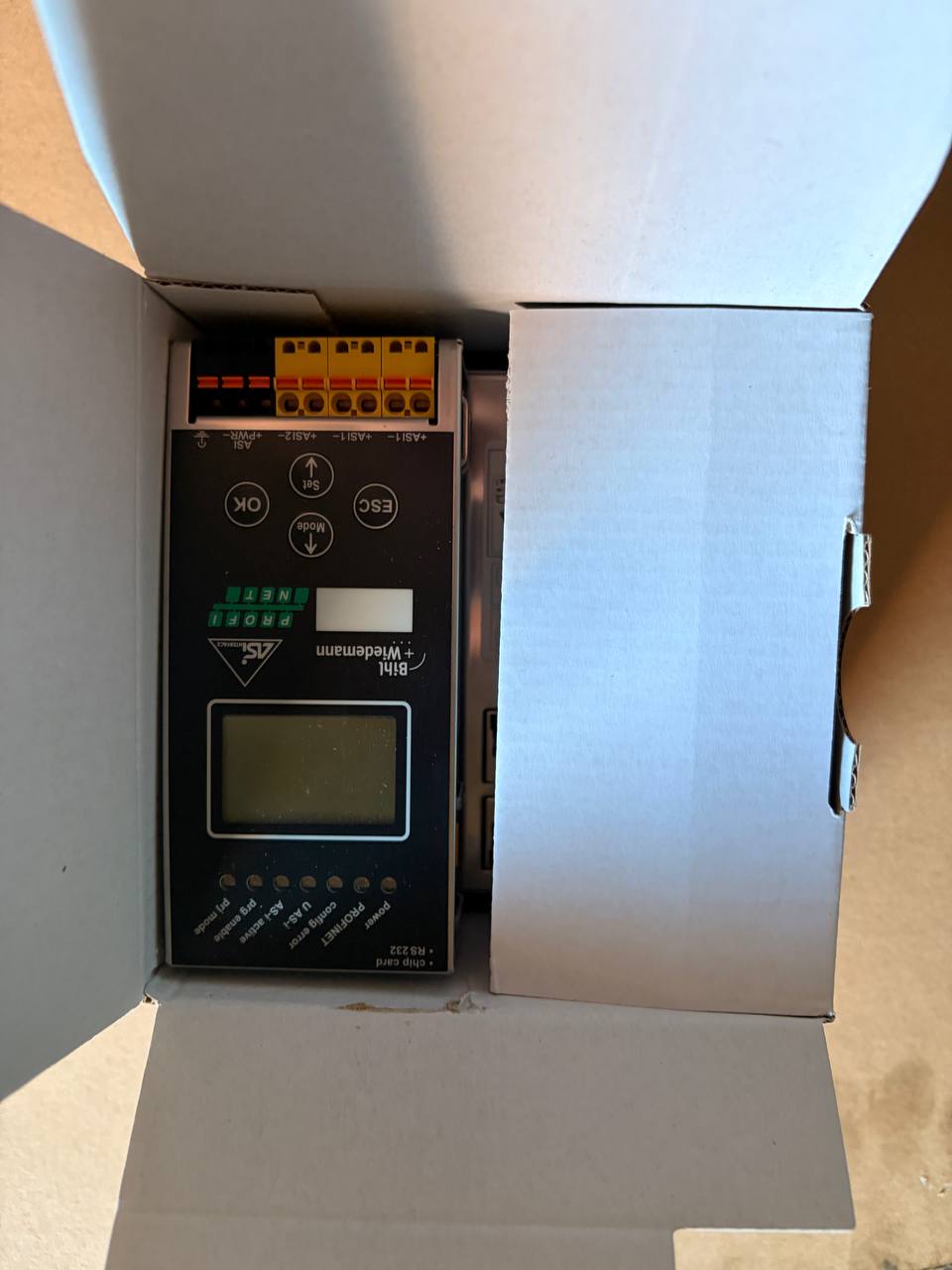 Electrical control panel inside an open cardboard box