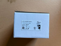 White electronic device packaging with labels on a brown surface