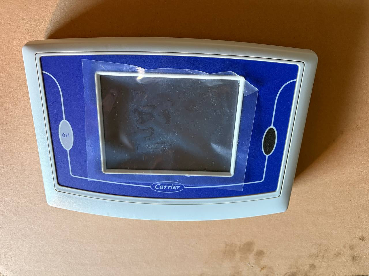 Carrier HMI - Electronic device with a screen on a beige background