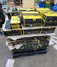FANUC surplus lot: Stacked pallet of FANUC modules including larger spindle and power supply units