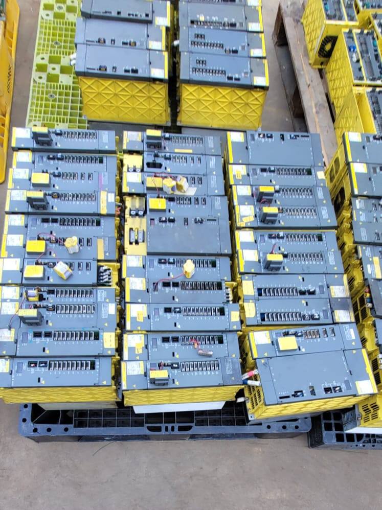 FANUC surplus lot: Rows of FANUC amplifier modules on pallets, top view