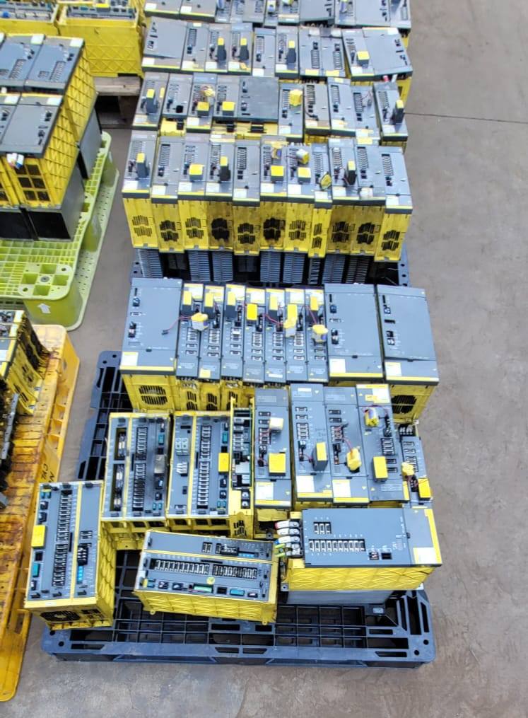 FANUC surplus lot: Stack of FANUC amplifier modules on a pallet, top view