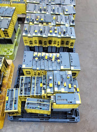 FANUC surplus lot: Stack of FANUC amplifier modules on a pallet, top view