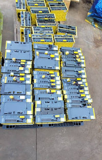 FANUC surplus lot: FANUC alpha amplifier modules stacked on a pallet, top view