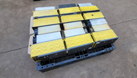 FANUC surplus lot: FANUC modules laid flat on a pallet, yellow covers and heatsinks