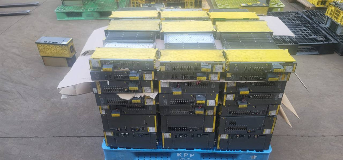 FANUC surplus lot: Stacked pallet of FANUC modules, side view