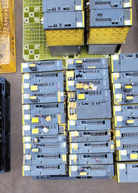 FANUC surplus lot: Rows of FANUC servo amplifier modules, top view