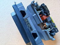 Close-up of a mechanical component with visible branding on a lightbackground