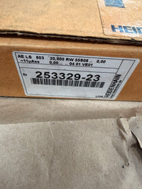 Cardboard box with a label featuring a barcode and text.
