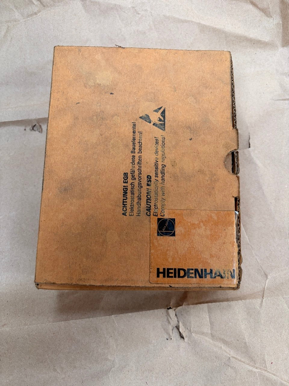 Cardboard box with HEIDENHAIN branding on a white background