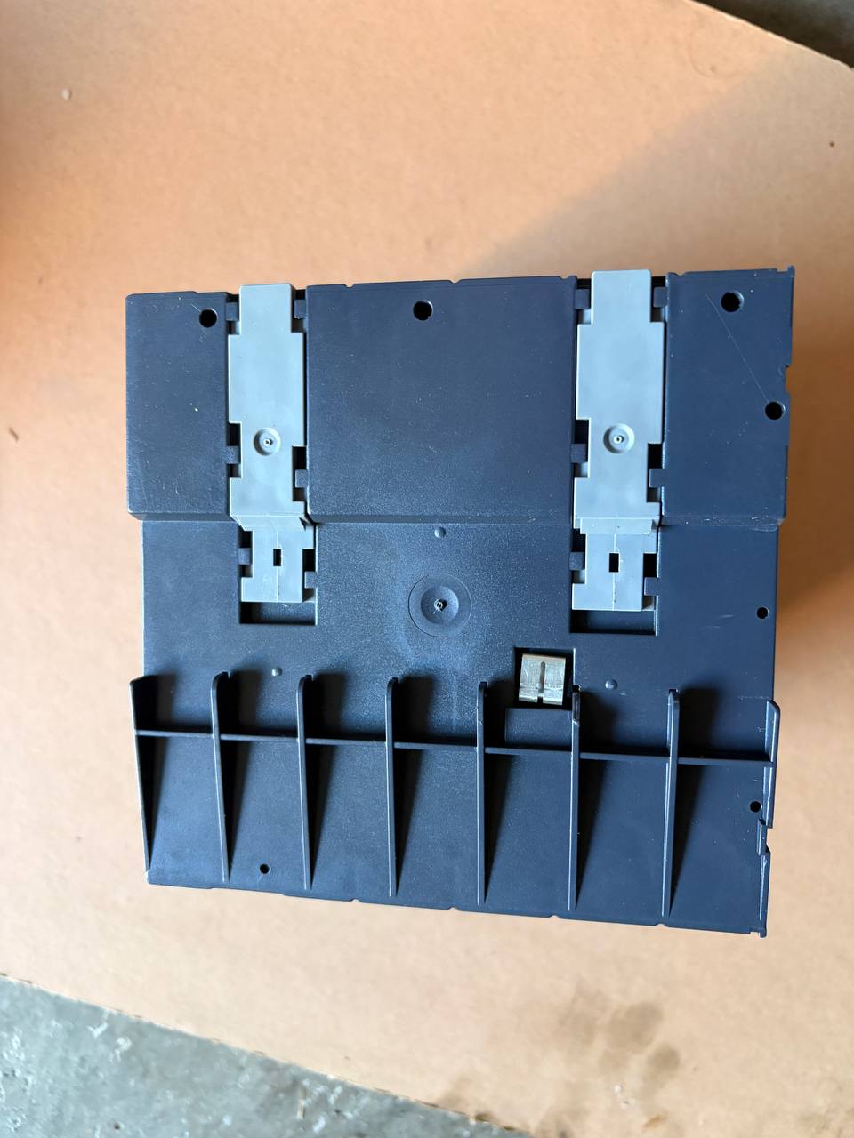 Plastic component on a beige surface