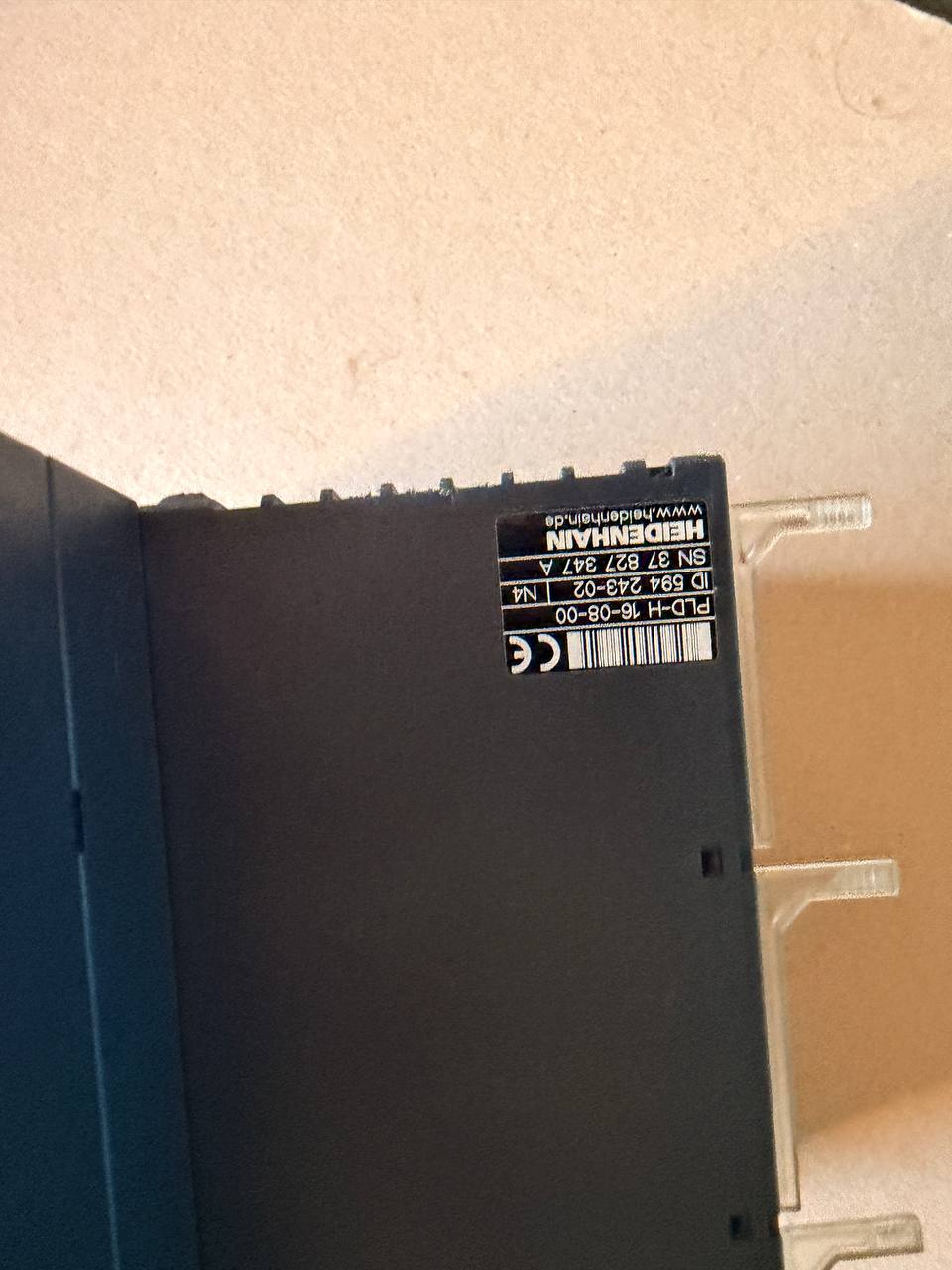 Back of a electronic device - Heidenhain -  with labels on a beige surface