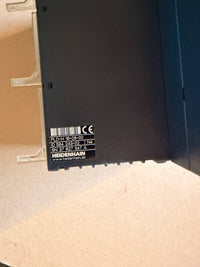 Back of a electronic device - Heidenhain -  with labels on a beige surface