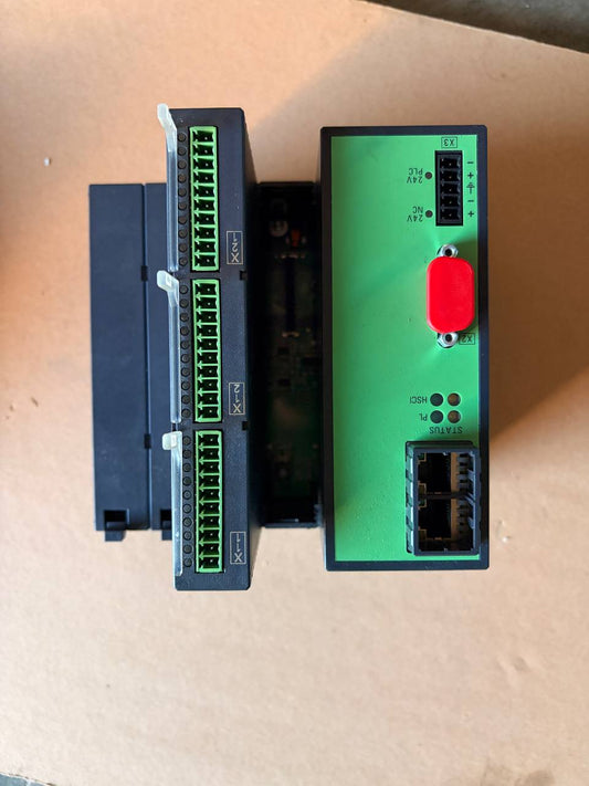 Heidenhain electronic modules on a beige surface, one green with ports and a red button, the other black with multiple ports.