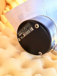 Heidenhain encoder - Close-up of a cylindrical object with a label on a textured surface