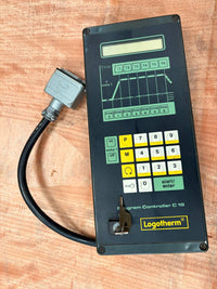 Control panel with digital display and keypad on a wooden surface