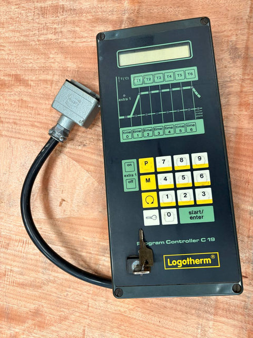 Control panel with digital display and keypad on a wooden surface