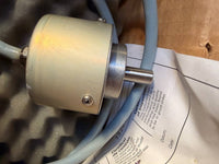 Heidenhain Encoder - Mechanical component with a cable on a printed paper background