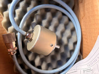Mechanical component with a hose and valve on a textured background