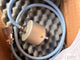 Mechanical component with a hose and valve on a textured background