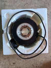 Heidenhain Mechanical component on a white square block with a brown background