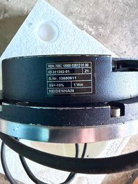 Heidenhain Mechanical component with a label on a concrete surface
