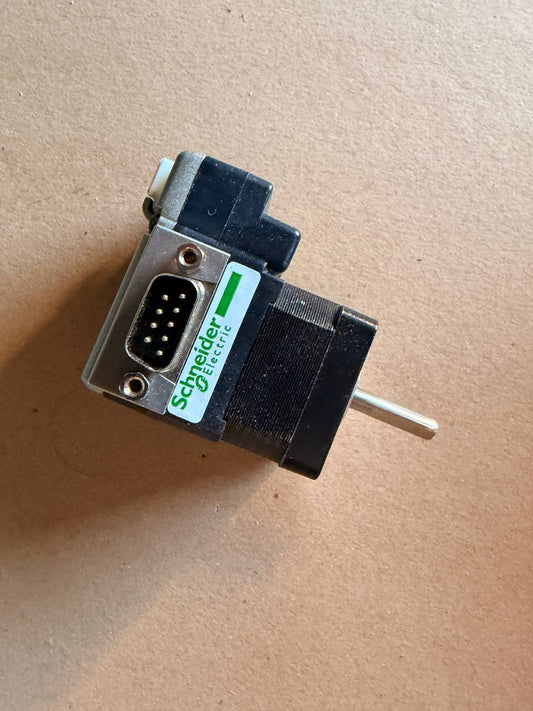 Mechanical switch with Schneider Electric logo on a beige background