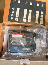 Electrical control panel in clear plastic wrap on a cardboard box