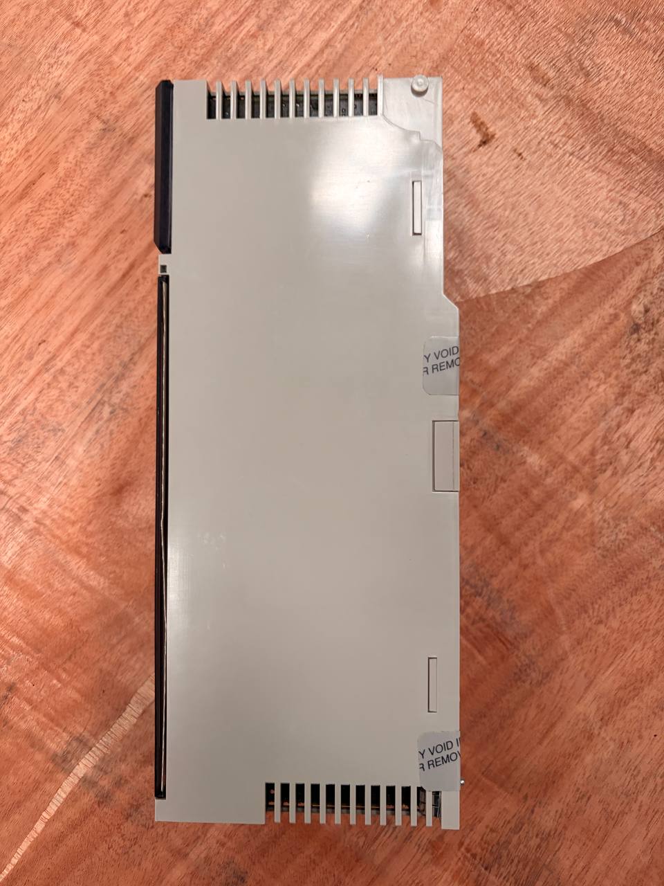 Metallic electronic component on a wooden surface