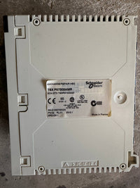 Electrical component with Schneider Electric label on a concrete surface