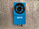 Blue sensor with 'SICK' branding on a bubble wrap background