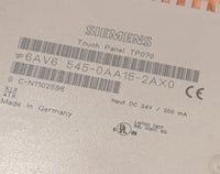 Siemens touch panel with label and certification logos on a metallic surface