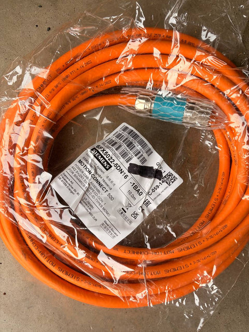 Siemens Motion connect Orange cable with labels on a clear plastic wrap against a brown background