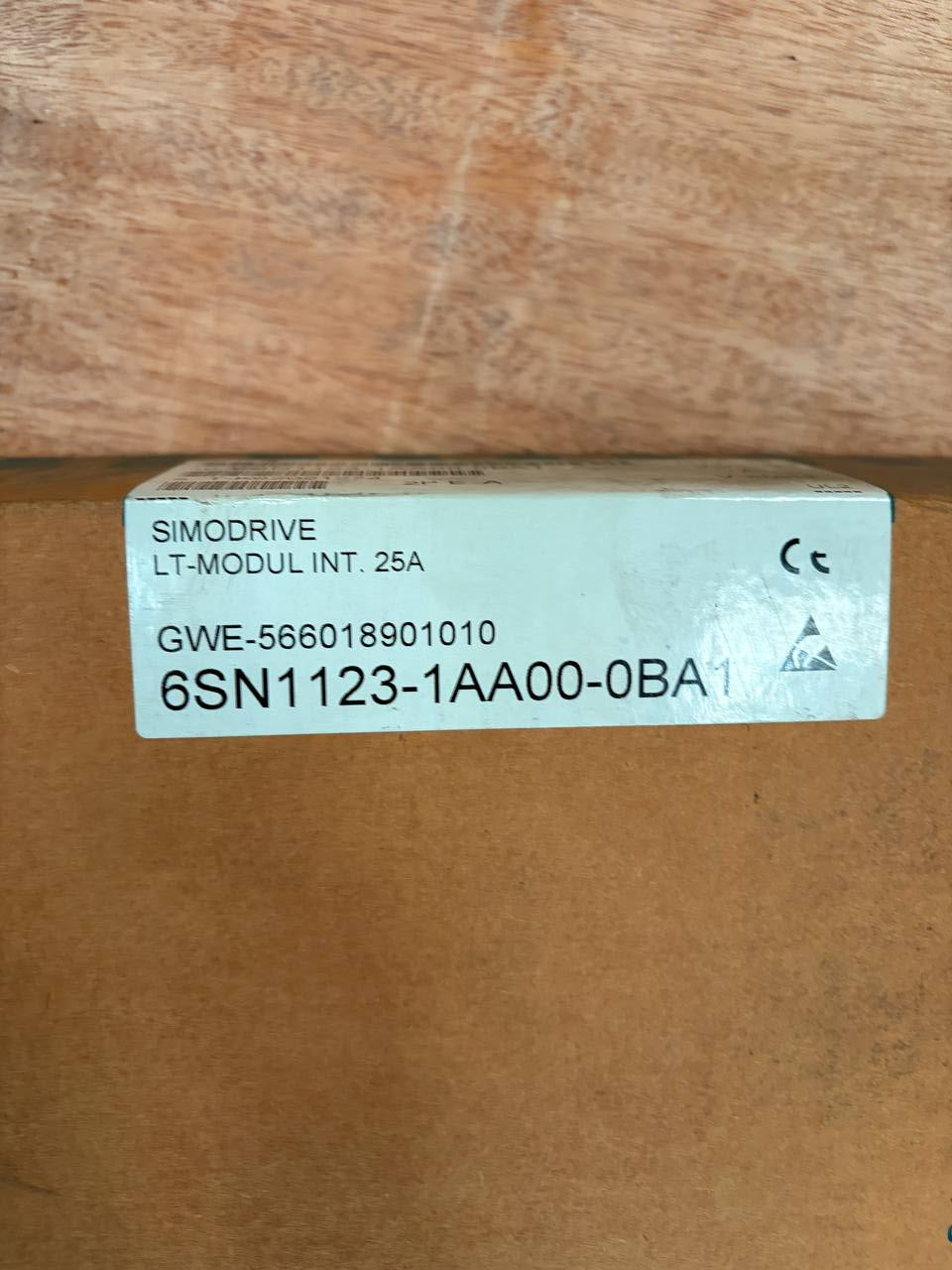 Small rectangular box with text and symbols on a wooden surface