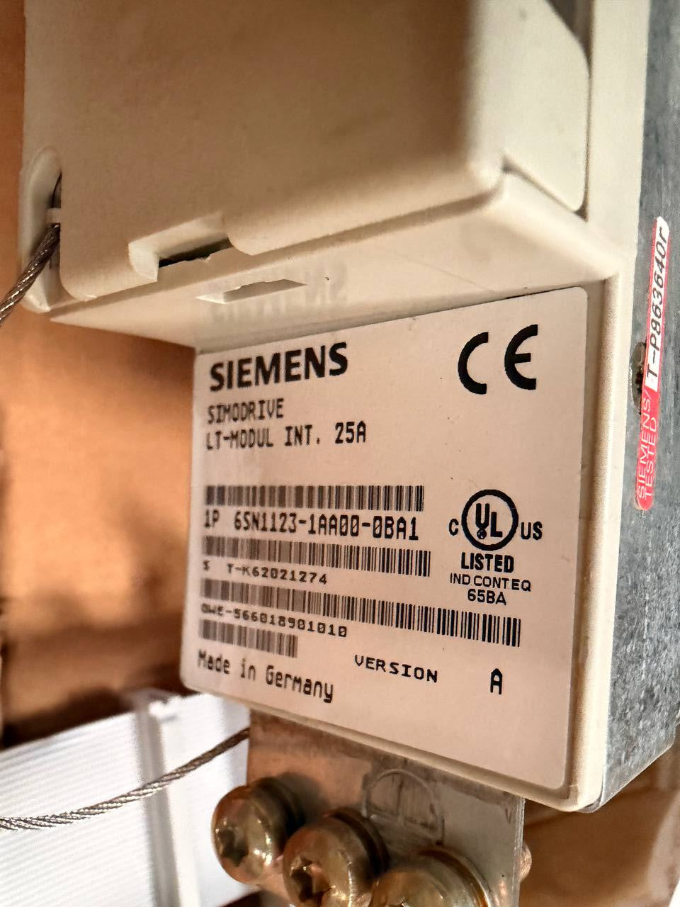 Siemens device with visible branding and certification marks on a blurred background