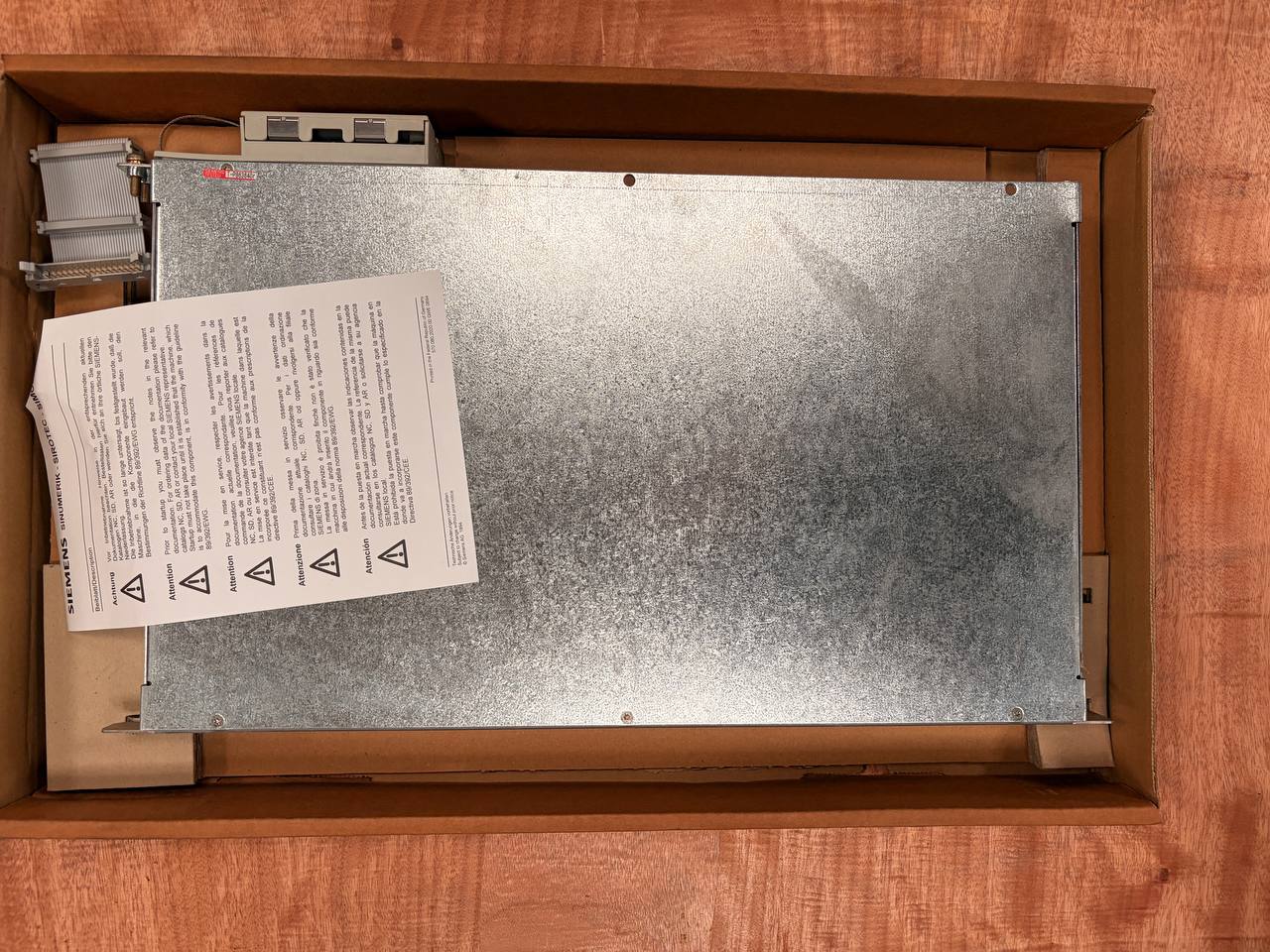Metal panel with text and symbols in a wooden box