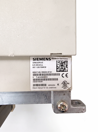 Close-up of a Siemens SimDrive E-Module label on a beige industrial electrical component, showing model details and barcodes.
