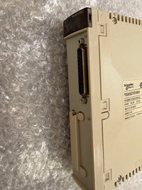 Schneider Electric TSXSCY216001 industrial electronic module in beige plastic, photographed on bubble wrap packaging.