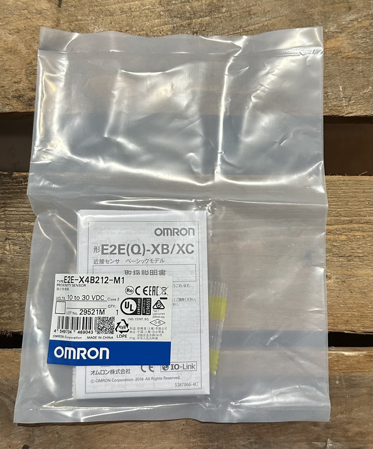 Omron E2E-X4B212-M1 inductive proximity sensor in its original bag with label and instruction sheet